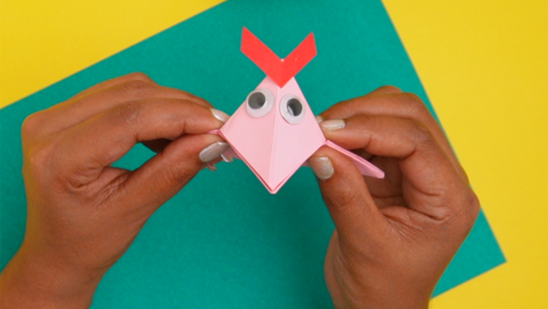 Finished origami paper bird craft featuring a folded paper bird with pointed wings, a beak, and a simple handmade design.